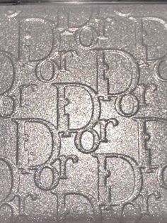 a close up of a glittered purse with the word dior on it