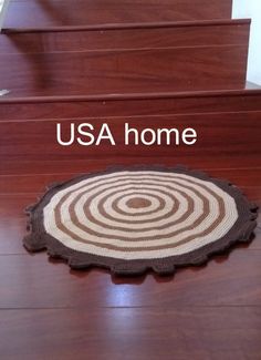 a wooden stair case with the words usa home on it and an image of a circular rug