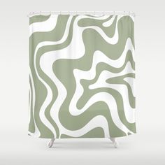 a green and white shower curtain with wavy lines