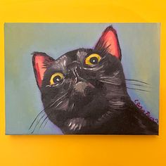 a painting of a black cat with yellow eyes