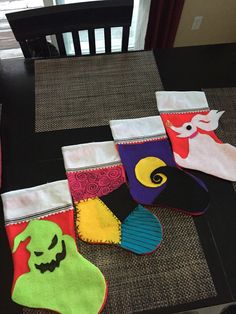 five halloween stockings are sitting on the table