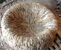 a stone chair sitting on top of a pile of rubble