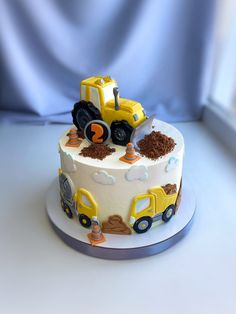 a birthday cake decorated with construction vehicles and dirt