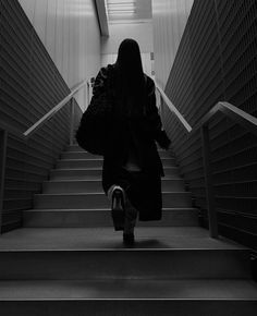 a woman is walking down some stairs