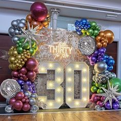 there are balloons and disco balls in front of the number 30 sign that says thirty