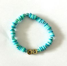 XG K-pop girl group beaded bracelet. Green, blue and gold, fun and lightweight. perfect for ALPHAZ! Trendy Blue Stretch Bracelet With Letter Beads, Adjustable Blue Name Bracelet With Colorful Beads, Kpop Style Blue Beaded Bracelets As Gift, Blue Kpop Style Beaded Bracelet Gift, Casual Blue Beaded Name Bracelet, Adjustable Blue Kpop Bracelets, Trendy Blue Name Bracelet With Letter Beads, Blue Name Bracelet With Colorful Round Beads, Casual Blue Name Bracelet With Round Beads