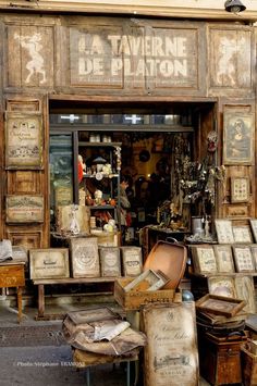 an old store front with lots of items on display