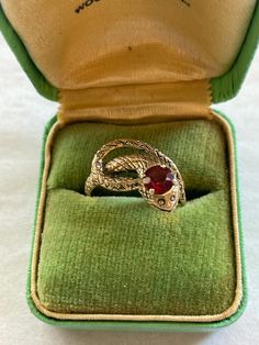 Vintage 14k yellow gold and garnet carved snake ring  Size.5.5 4.3 grams Formal Yellow Gold Snake Ring, 14k Gold Snake Ring For Anniversary, 14k Gold Snake Shape Ring For Anniversary, Heirloom 14k Gold Snake Ring For Formal Occasions, Antique Gold Snake Ring For Formal Occasions, Formal Gold Gemstone Snake Ring, Antique 14k Gold Snake Ring For Anniversary, Vintage 14k Gold Snake Ring As A Gift, Vintage Engraved Snake Ring Gift