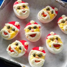 an assortment of deviled eggs decorated to look like santa claus's face and smiling faces