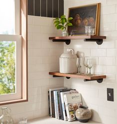 two shelves with books and vases on them in a room next to a door