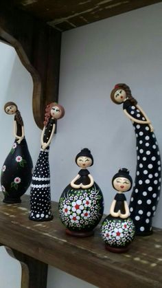 a group of figurines sitting on top of a wooden shelf