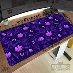 purple flowers and crescents are on the floor in front of a computer monitor screen