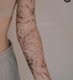 a woman's arm with flowers on it and the bottom half of her arm