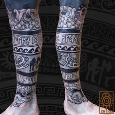 the legs and ankles of a man with tattoos