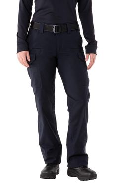 a man standing in front of a white background wearing dark blue pants and black shoes