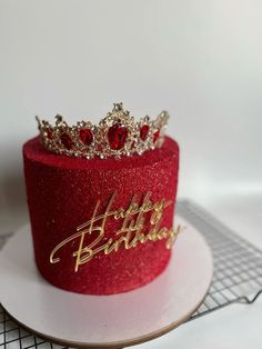 a red birthday cake with a tiara on top