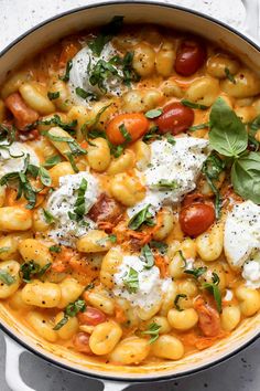 a pot filled with pasta and cheese on top of a table