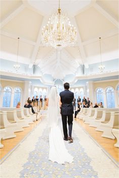 the bride and groom are walking down the aisle