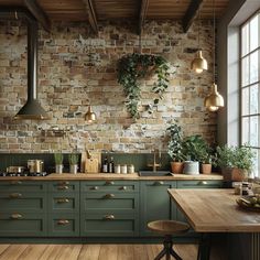 a kitchen with green cabinets and wooden floors is decorated with potted plants on the wall