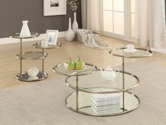 three glass tables sitting on top of a rug in front of a white wall and floor