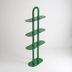 a three tiered green shelf on a white background with no one around it or someone else