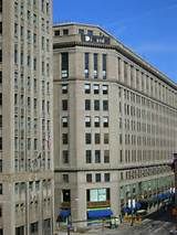 a large building with lots of windows on the side of it's face in front of a blue sky