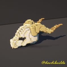 a lego model of an alligator made out of white and yellow bricks, sitting on a black surface