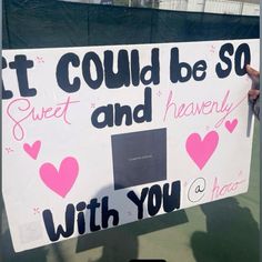 a person holding up a sign that says it could be so sweet and heavenly with you