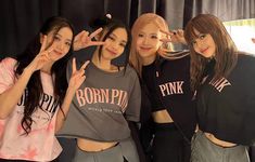 four girls posing for the camera with their fingers up