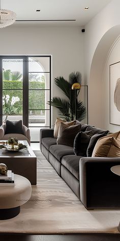 a living room filled with lots of furniture and a large glass door leading to a balcony