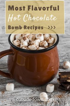 hot chocolate in a mug with marshmallows on the side and a sign that says most flavorful hot chocolate bomb recipes