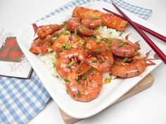 shrimp and rice on a plate with chopsticks