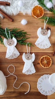 christmas decorations on a wooden table with oranges and other things to make it look like an angel