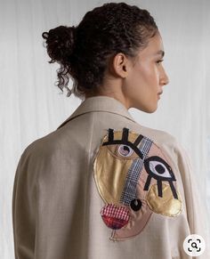 a woman wearing a jacket with an eye on it