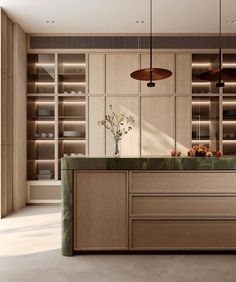 a kitchen with wooden cabinets and green counter tops in front of an open bookcase