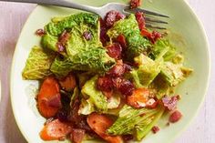 a white plate topped with lettuce and bacon next to a bowl of broccoli