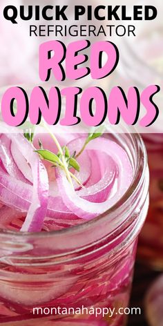 a jar filled with red onions sitting on top of a table