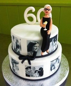 a birthday cake decorated with photos and a woman holding a wine glass in her hand