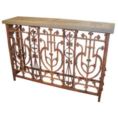 an iron and wood console table with marble top