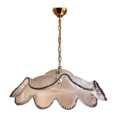 a glass light hanging from a chain