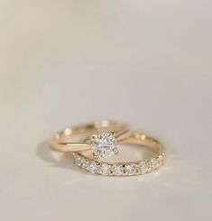 two gold wedding rings with diamonds on them