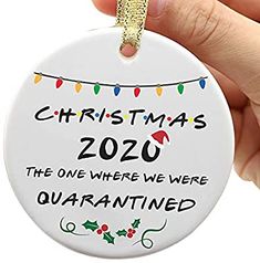 a hand holding a christmas ornament that reads, christmas 2020 the one where we were quarannated