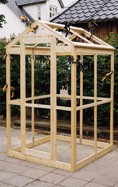 a small wooden structure sitting in front of a house