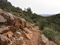 a rocky trail with lots of rocks on the side