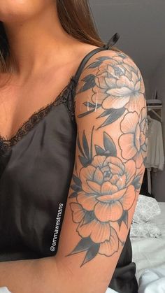 a woman with a flower tattoo on her arm