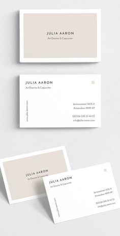 two white business cards with minimal lines on the front and back, one in grey