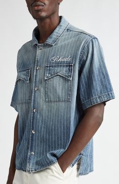 Rhuigi Villaseñor draws inspiration from traditional Americana aesthetics with this snap-front denim shirt faded to old-favorite perfection. 26" front length, 27" back length (size Medium) Front snap closure Spread collar Short sleeves Front flap-patch pockets Side slits 100% cotton Made in the USA Dry clean Classic Pre-washed Denim Tops, Classic Denim Tops Pre-washed, Unstructured Denim Blue Washed Top, Faded Denim Tops With Pockets, Vintage Stonewashed Tops For Spring, Unstructured Washed Shirt In Medium Wash, Faded Denim Button-up Tops, Spring Denim Top, Pre-washed, Spring Denim Tops Pre-washed