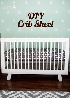 a white crib in front of a wall with the word dry crib sheet on it