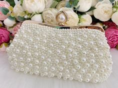 This elegant bridal clutch features gold trim, attachable chain and large enough for your phone. Complete your list of must-have wedding accessories with the ultimate bridal accessory to finish off your look and storing your wedding day essentials. Details： Inside Material: Satin Size: 9.8*1.6*5.1inch/25*4*13cm Come with a removable short chain（37cm） and a long chain（116cm) and a pearl chain that can be used as shoulder bag or crossbody bag or as clutch. Request a cancellation within 24 hours of Wedding Day Essentials, Pearl Purse, Pearl Clutch Bag, Purse Wedding, Pearl Clutch, Wedding Bags, Bridal Accessory, Wedding Clutch, Bridal Clutch