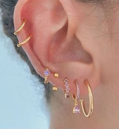 a close up of a person with ear piercings on their ears and behind the ear